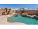 Inviting backyard pool and spa with rock waterfall, surrounded by mature landscaping and privacy walls at 15903 N 138Th Ave, Surprise, AZ 85374