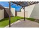 Charming backyard features artificial turf, a pergola, and privacy walls, ideal for relaxation or entertaining at 1616 S Torre Molinos Cir, Tempe, AZ 85281