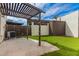 Inviting backyard with artificial turf, concrete patio and pergola, offering a perfect relaxation area at 1616 S Torre Molinos Cir, Tempe, AZ 85281