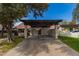 View of covered carport with stucco walls and decorative wood shade structure at 1616 S Torre Molinos Cir, Tempe, AZ 85281