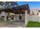 View of covered carport with stucco walls and decorative wood shade structure at 1616 S Torre Molinos Cir, Tempe, AZ 85281