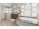 Luxurious bathroom features a soaking tub, marble shower, and glass block window accents at 16670 N 109Th Way, Scottsdale, AZ 85255