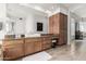 Elegant bathroom showcasing wood cabinetry, a vessel sink, and a large mirror with vanity at 16670 N 109Th Way, Scottsdale, AZ 85255