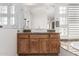 Stylish bathroom with a large mirror, wood cabinets, and a modern sink at 16670 N 109Th Way, Scottsdale, AZ 85255