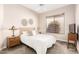 Bedroom featuring a queen bed, neutral paint, ceiling fan and bright window at 16670 N 109Th Way, Scottsdale, AZ 85255