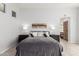 Comfortable bedroom with a gray bedspread, decorative pillows, and matching nightstands with lamps at 16670 N 109Th Way, Scottsdale, AZ 85255