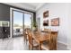 Bright dining room with wood table, elegant chairs, art, and a view to the outside patio at 16670 N 109Th Way, Scottsdale, AZ 85255