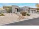 Modern home with desert landscaping, rocks, and low-water plants for an inviting curb appeal at 16670 N 109Th Way, Scottsdale, AZ 85255
