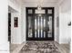 Grand foyer featuring decorative front doors, a chandelier, and wood-style tile flooring at 16670 N 109Th Way, Scottsdale, AZ 85255