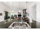 Open-concept kitchen with a view of the living room and fireplace, featuring a large island sink at 16670 N 109Th Way, Scottsdale, AZ 85255