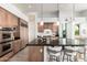 Bright kitchen boasts a large island with seating, stainless steel appliances, and wood cabinetry at 16670 N 109Th Way, Scottsdale, AZ 85255