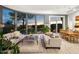 Bright living room with hardwood floors, comfortable seating, and beautiful backyard views at 16670 N 109Th Way, Scottsdale, AZ 85255