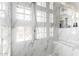 Spa-like shower with marble tiling, glass block accents, and modern fixtures at 16670 N 109Th Way, Scottsdale, AZ 85255