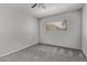 Cozy bedroom with plush carpeting, ceiling fan, and a sun-filled window, creating a relaxing retreat at 17242 N 16Th Dr # 6, Phoenix, AZ 85023