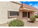 Tan home with a red tile roof, security bars, and xeriscaping for easy maintenance in a sunny environment at 17242 N 16Th Dr # 6, Phoenix, AZ 85023