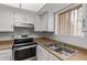 A pristine kitchen with stainless steel oven and a view from the window to a bright sunny day at 17242 N 16Th Dr # 6, Phoenix, AZ 85023