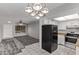 Bright kitchen featuring white cabinetry, modern appliances, and an adjoining living area perfect for entertaining at 17242 N 16Th Dr # 6, Phoenix, AZ 85023
