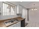 Bright kitchen area features a double sink with neutral countertops and black appliances, enhancing functionality and style at 17242 N 16Th Dr # 6, Phoenix, AZ 85023