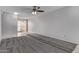 Neutral living room with gray carpeting and tile floor, and a dining area with chandelier in the background at 17242 N 16Th Dr # 6, Phoenix, AZ 85023