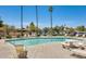 Well-maintained community pool with deck furniture, tables and lush greenery, perfect for socializing and relaxing at 17242 N 16Th Dr # 6, Phoenix, AZ 85023