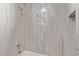 Beautifully remodeled shower with decorative vertical tiling, a rainfall showerhead, and built in nook at 17242 N 16Th Dr # 6, Phoenix, AZ 85023