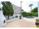 This backyard features a cozy fireplace, built-in grill, and a sparkling pool for outdoor entertainment at 1731 E Evans Dr, Phoenix, AZ 85022