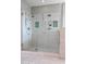 Modern glass shower with dual shower heads, convenient built-in niches, and tiled walls for a sleek look at 1731 E Evans Dr, Phoenix, AZ 85022