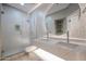 Modern bathroom featuring a double vanity with a round mirror and a walk-in shower with a glass door at 1731 E Evans Dr, Phoenix, AZ 85022