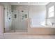 Luxurious bathroom featuring a glass-enclosed shower, soaking tub, and dual shower heads for a spa-like experience at 1731 E Evans Dr, Phoenix, AZ 85022