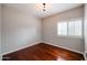 Bright, modern bedroom with hardwood floors, neutral walls, and a window with plantation shutters at 1731 E Evans Dr, Phoenix, AZ 85022
