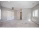 Spacious bedroom with neutral walls, plush carpet, ceiling fan, and natural light from shuttered windows at 1731 E Evans Dr, Phoenix, AZ 85022