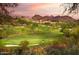 Scenic golf course view with lush green fairways, mountain views, and beautiful desert landscaping at 1731 E Evans Dr, Phoenix, AZ 85022