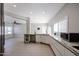Open kitchen featuring stone countertops, stainless steel appliances, and seamless flow to the living area at 1731 E Evans Dr, Phoenix, AZ 85022