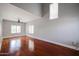 Bright living room features hardwood floors, large windows, a high ceiling and a modern ceiling fan at 1731 E Evans Dr, Phoenix, AZ 85022