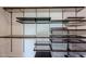 Custom walk-in closet with dark wood shelves, drawers, and wire baskets for organized storage at 1731 E Evans Dr, Phoenix, AZ 85022
