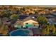 Stunning aerial view of a home with a sparkling pool and lush landscaping, set against a backdrop of beautiful mountains at 1822 N Sunaire Cir, Mesa, AZ 85205