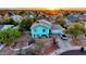 Aerial view of a charming home at sunset with mature trees and a well-manicured yard at 1822 N Sunaire Cir, Mesa, AZ 85205