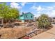 View of the backyard and exterior of the home showing rock features and mature trees at 1822 N Sunaire Cir, Mesa, AZ 85205