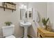 Powder room with a pedestal sink, modern fixtures, and wood flooring at 1822 N Sunaire Cir, Mesa, AZ 85205