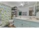 Bathroom with a double sink vanity and shower with blue and yellow floral curtain at 1822 N Sunaire Cir, Mesa, AZ 85205