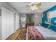 Bedroom featuring a king bed, hardwood floors, and white closet doors at 1822 N Sunaire Cir, Mesa, AZ 85205