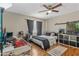 Cozy bedroom featuring ceiling fan, comfortable bed, modern furniture, and lots of personality at 1822 N Sunaire Cir, Mesa, AZ 85205