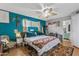 Bedroom featuring a king bed, teal accent wall, and hardwood floors at 1822 N Sunaire Cir, Mesa, AZ 85205