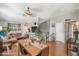 Bright dining room with wood floors, a dining table, and open to the living room at 1822 N Sunaire Cir, Mesa, AZ 85205