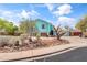 Charming two-story home with a manicured front yard featuring rock landscaping and mature trees at 1822 N Sunaire Cir, Mesa, AZ 85205