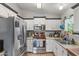 Bright kitchen featuring stainless steel appliances, ample counter space, and white cabinets with dark trim at 1822 N Sunaire Cir, Mesa, AZ 85205