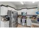 Kitchen featuring stainless steel appliances, white cabinets, and tile flooring at 1822 N Sunaire Cir, Mesa, AZ 85205