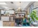 Bright kitchen with white cabinets, stainless steel appliances, butcher block counters, and island at 1822 N Sunaire Cir, Mesa, AZ 85205