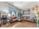 Bright living room with vaulted ceilings, wood floors, modern decor, and comfortable seating at 1822 N Sunaire Cir, Mesa, AZ 85205