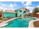 Inviting backyard pool with diving board, patio, landscaping, and direct access to the home at 1822 N Sunaire Cir, Mesa, AZ 85205